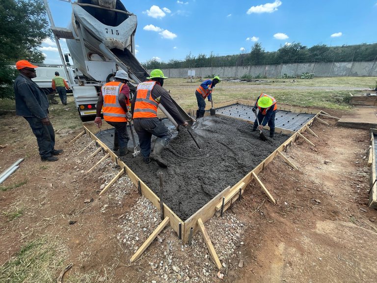 Eagle Projects crew placing reinforced concrete on site